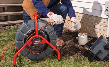 Photo of a 45th Parallel home inspector using a sewer scope